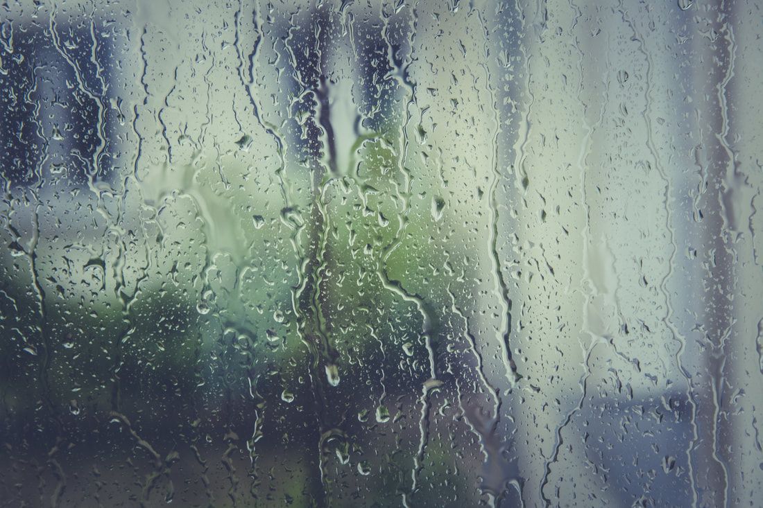 A close up of rain drops on a window.