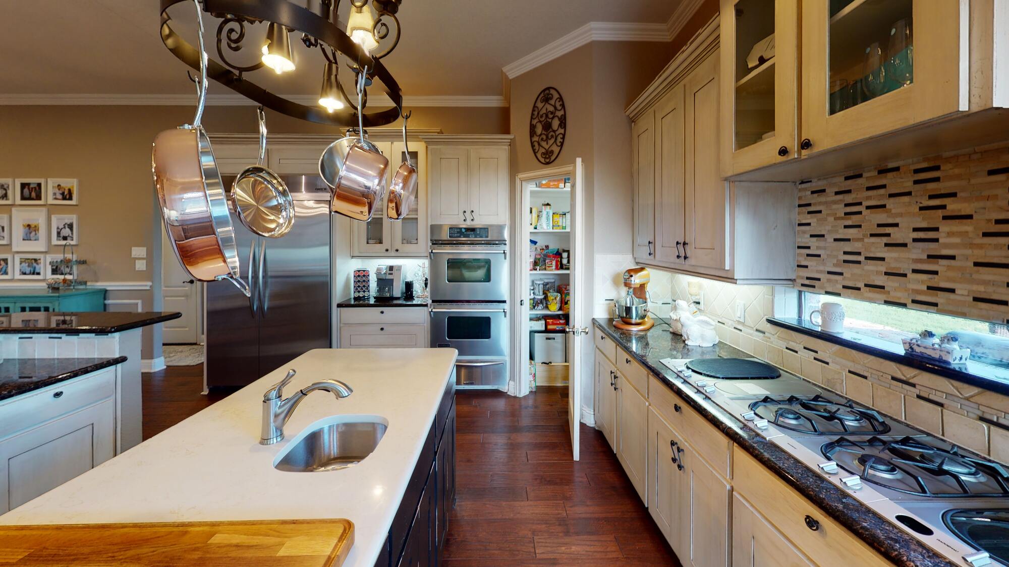 White subway tile in a kitchen backsplash behind stove