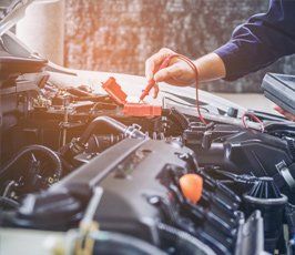 Auto Repair — Car mechanic repairing an internal combustion engine. in Hesperia, CA
