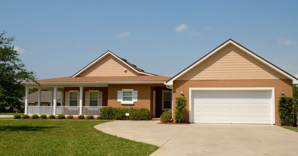 A house with a white garage door and a porch