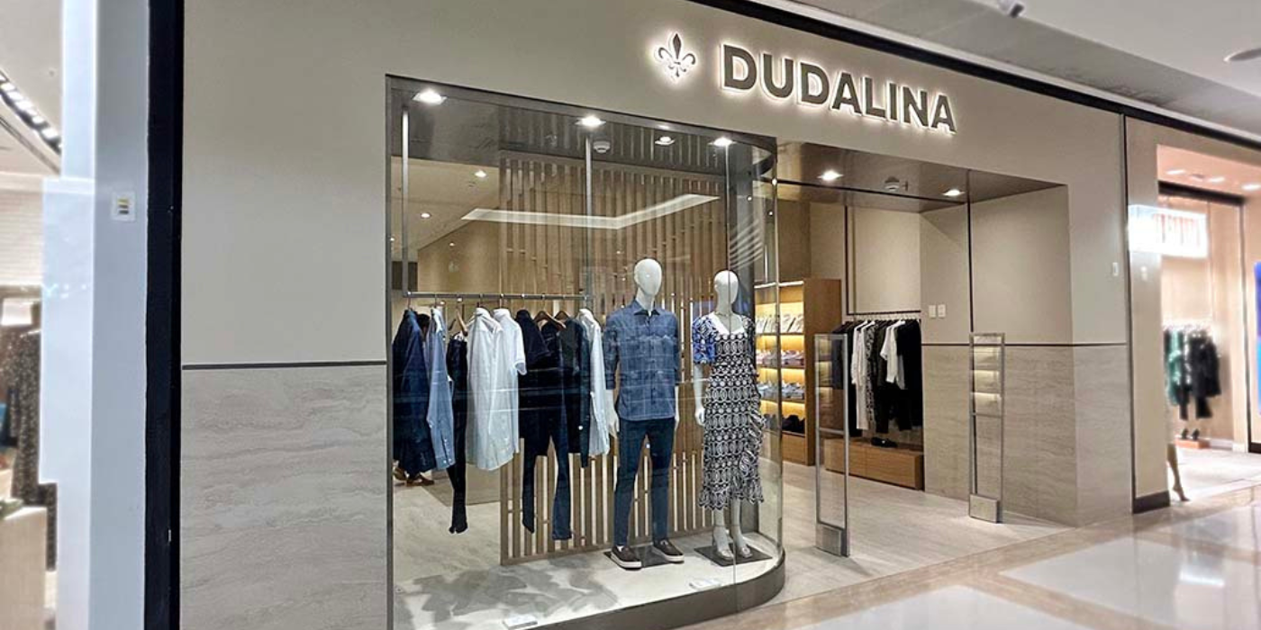 Dudalina clothing store storefront with mannequins and racks visible through glass windows
