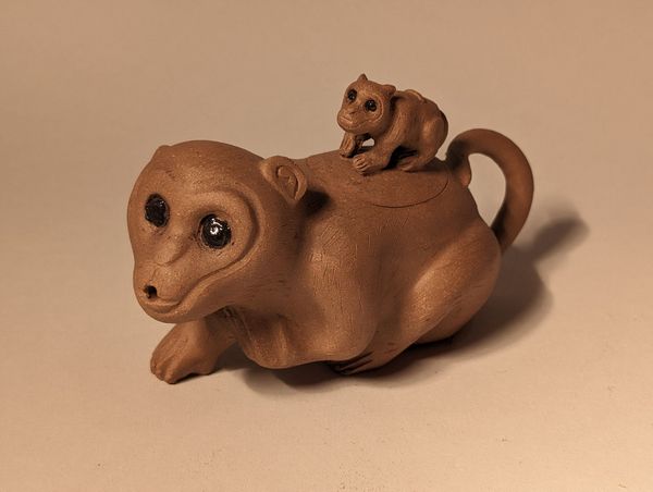 Brown teapot shaped like a bear with a tiny bear on its back