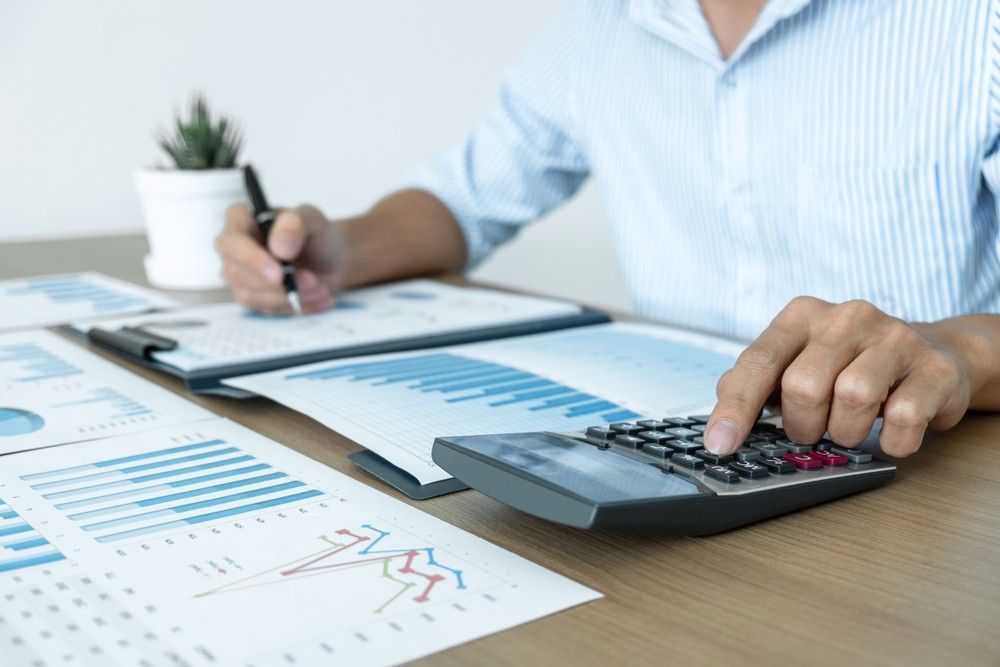 A Man and A Woman Are Sitting at A Table Talking to A Man — Marks Financial Group in  Toowoomba City, QLD