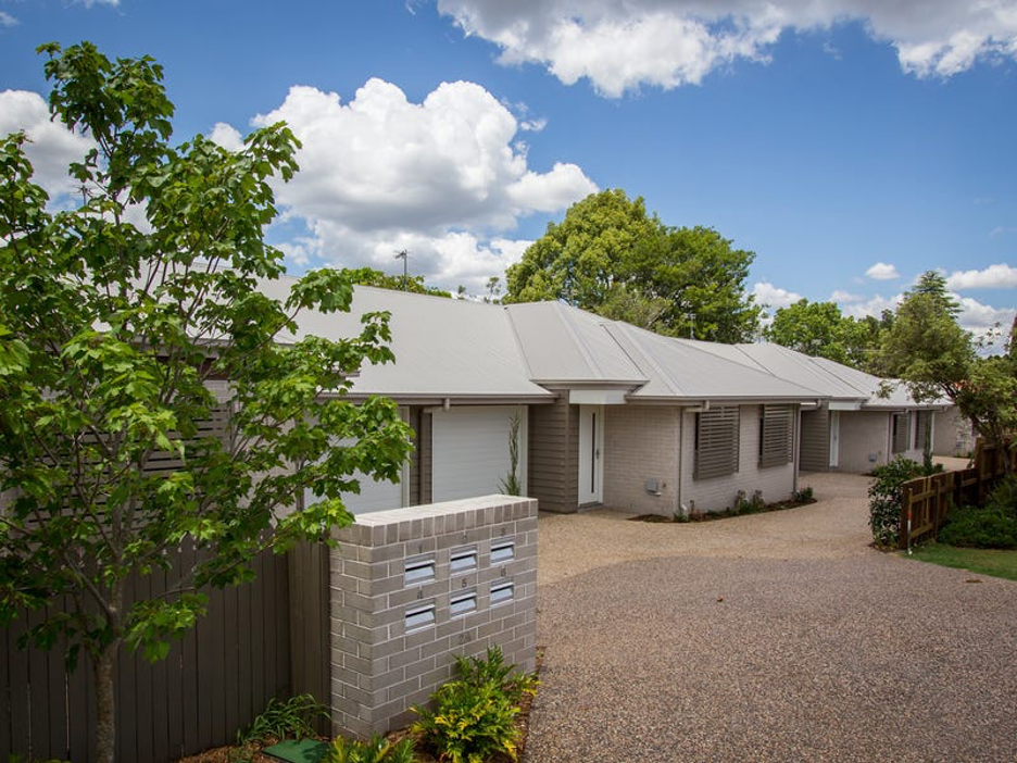 A Row of Apartment Buildings with A Lush Green Lawn in Front of Them — Marks Financial Group in  Toowoomba City, QLD