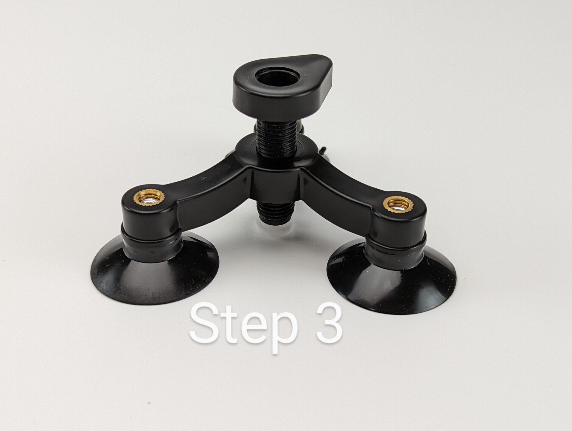 A black object with three suction cups and the words step 3 below it