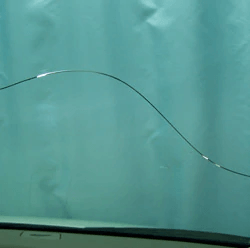 A close up of a cracked windshield on a car.