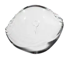 A clear glass ball with a hole in the middle on a white background.