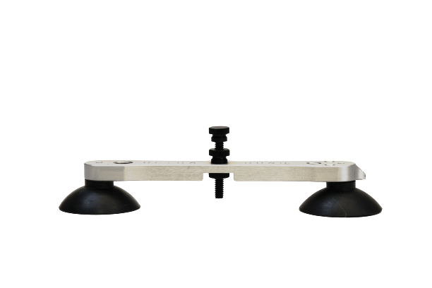 A white piece of plastic with two black suction cups attached to it.