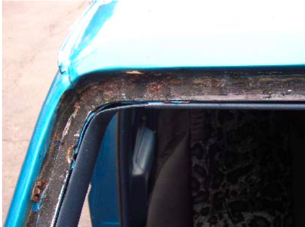 A close up of a blue car with a broken window