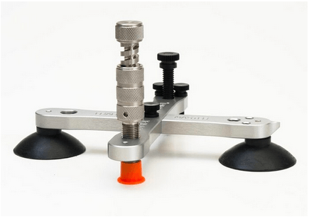 A tool with three suction cups on a white background