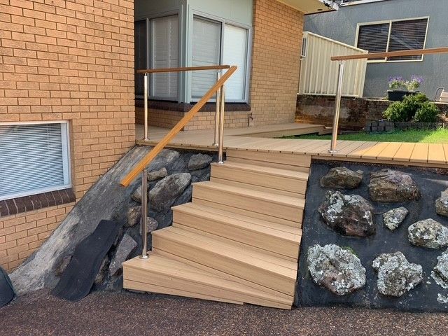 A set of wooden stairs leading up to a brick building
