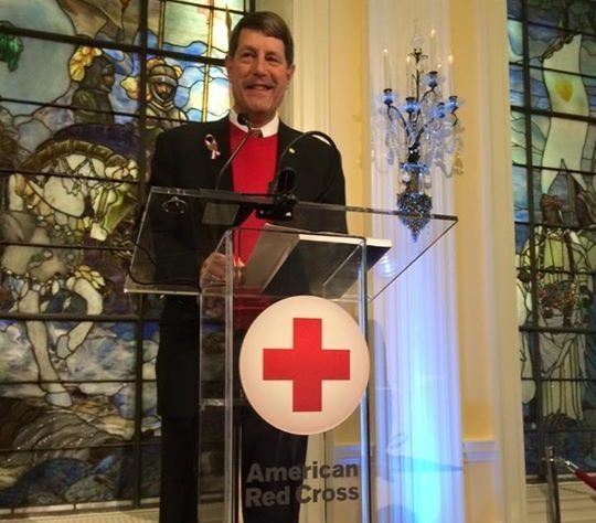 Joe Pereles at a podium with an american red cross logo on it.