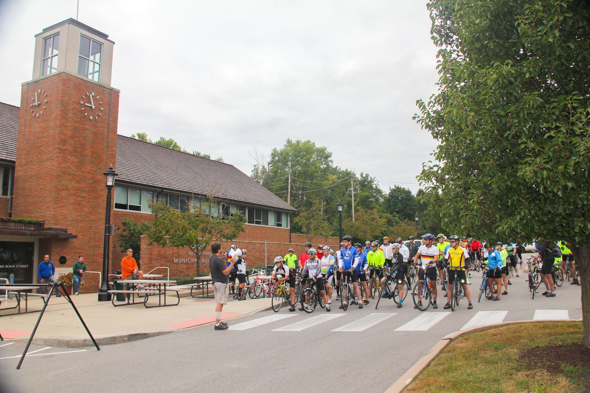 A group of people are riding bikes down a street. They are participating in the Wildwood race.