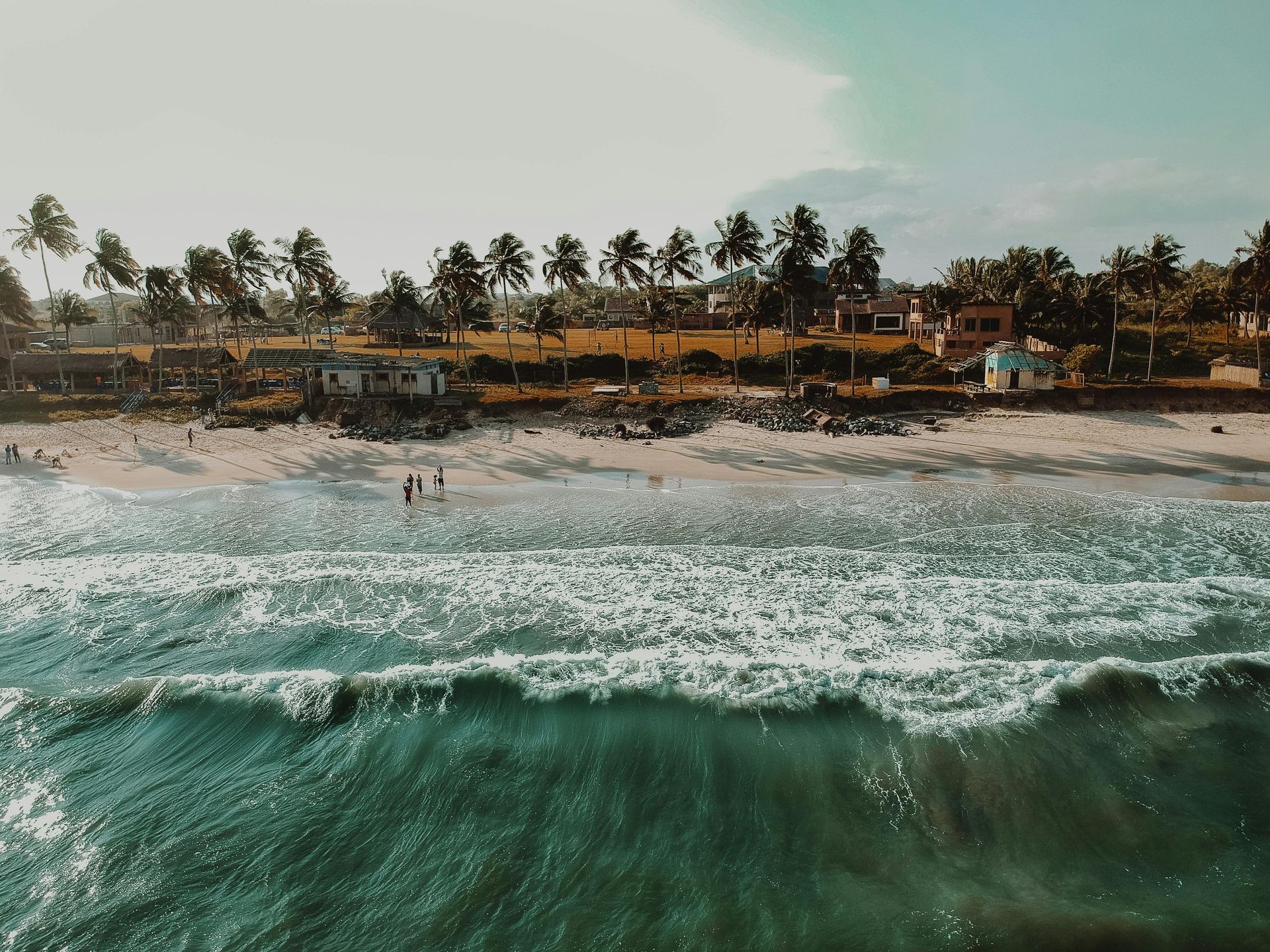 Rough waves on a vibrant Ghana beach, reflecting the powerful and evolving healthcare sector.