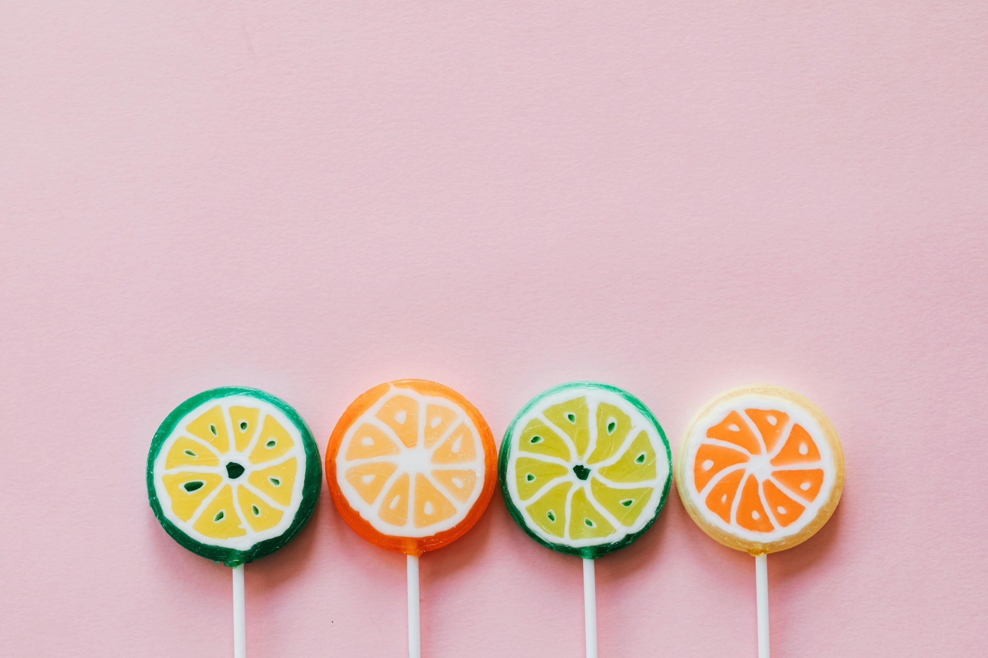 Four colourful lollipops symbolising lifestyle choices and moderation