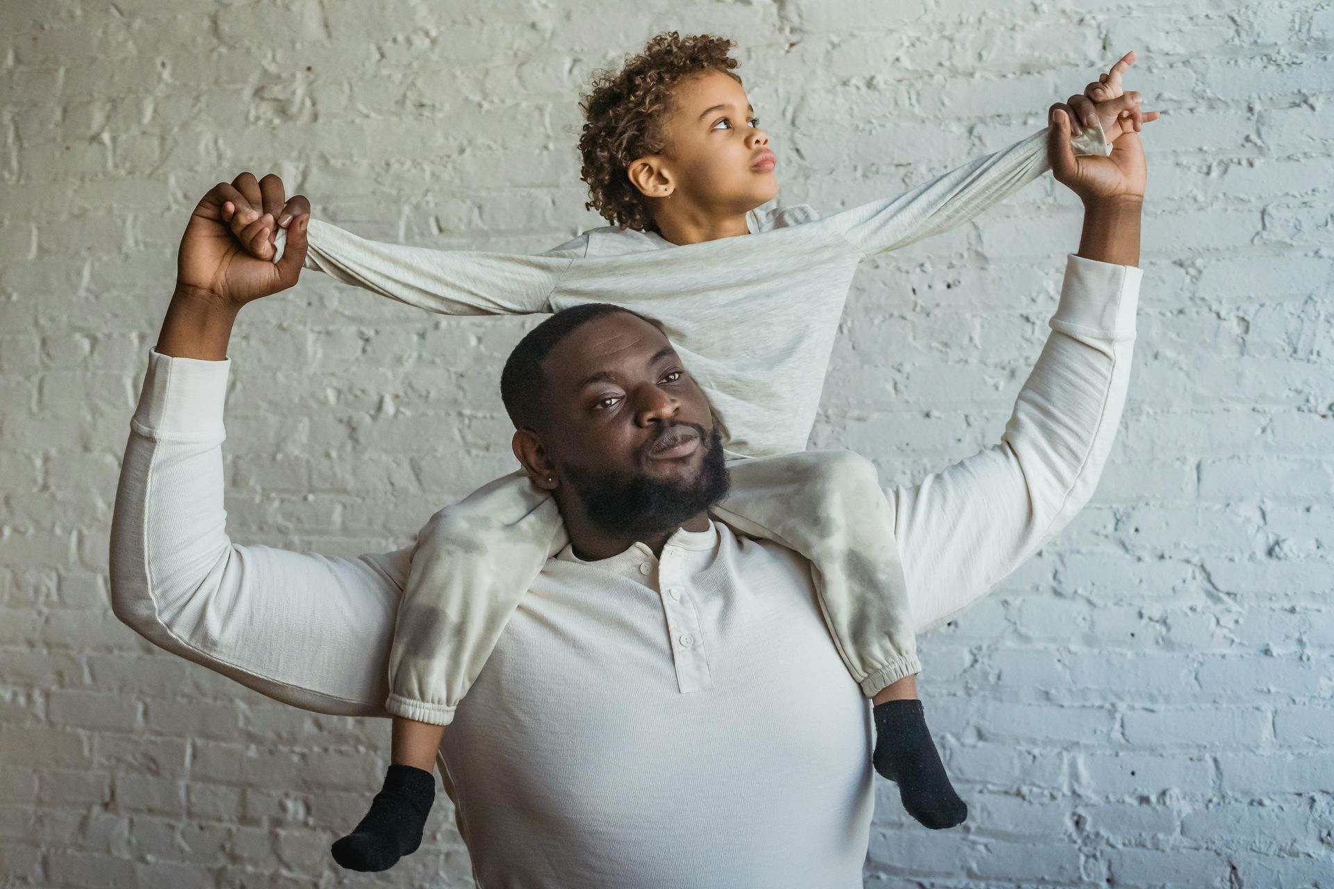 an african father with child carried behind his neck