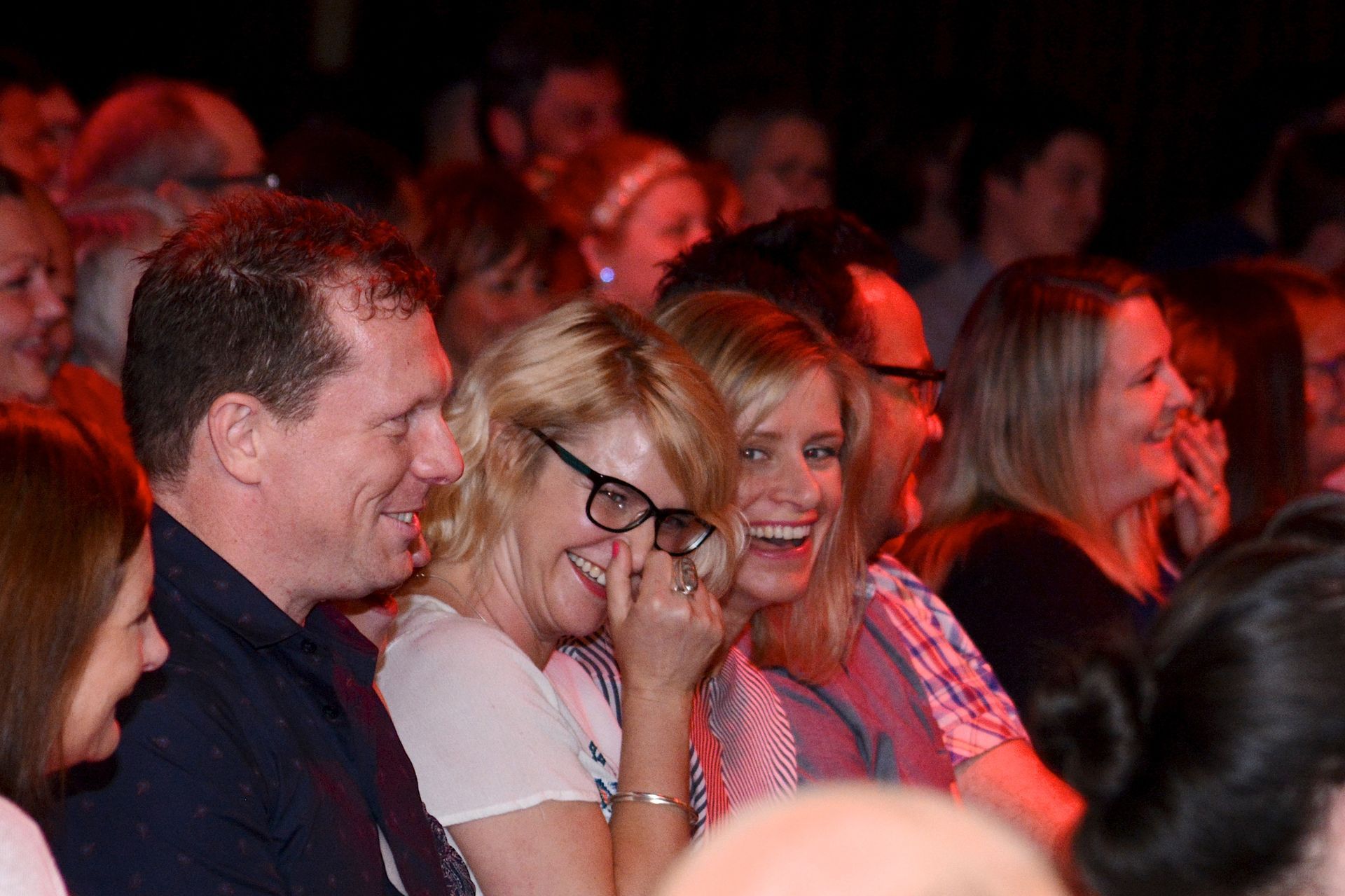 A man in a suit and tie is singing into a microphone.