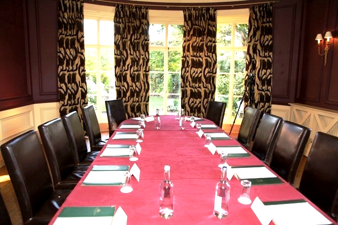 A conference room with a long table and chairs