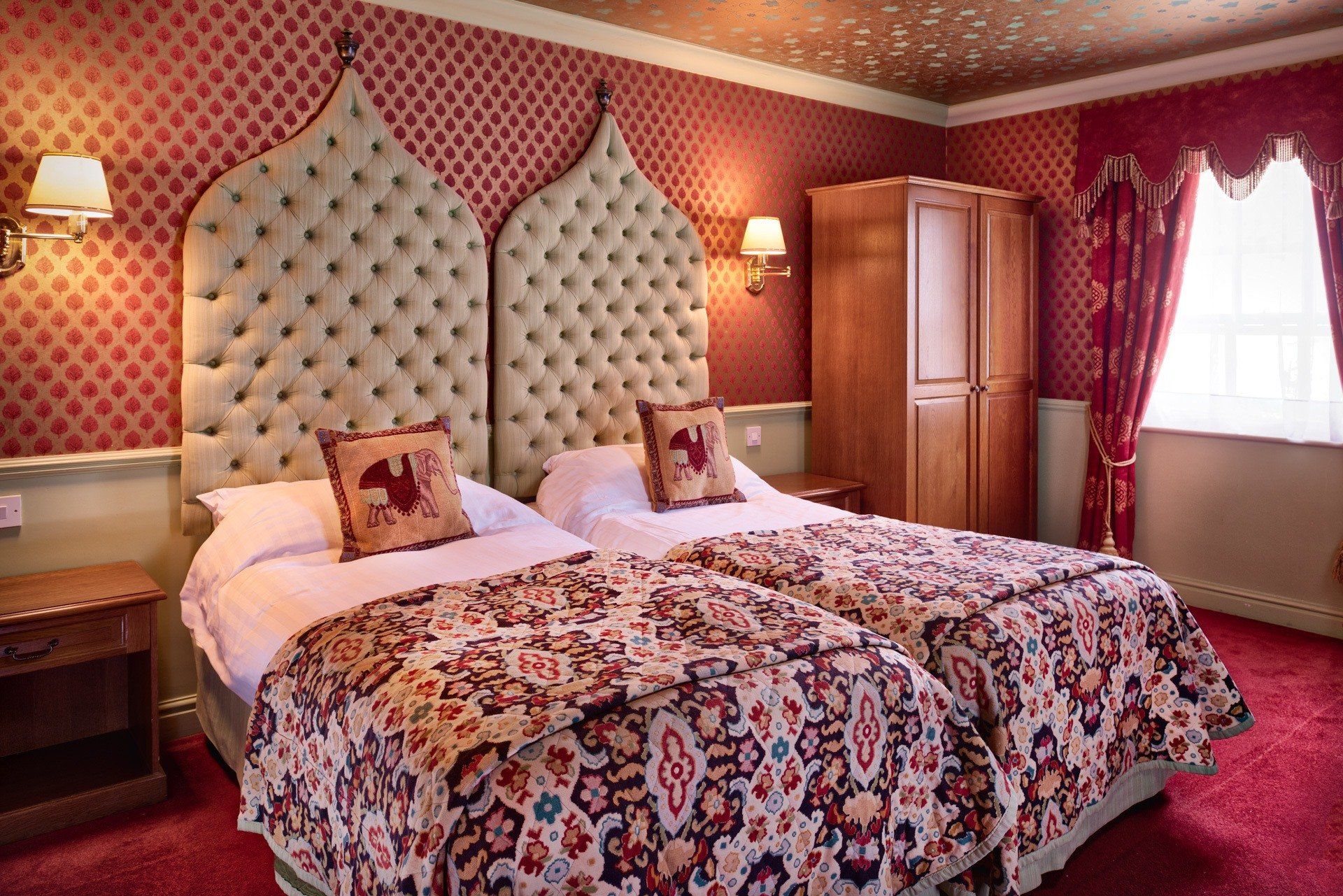 A hotel room with two beds and a window