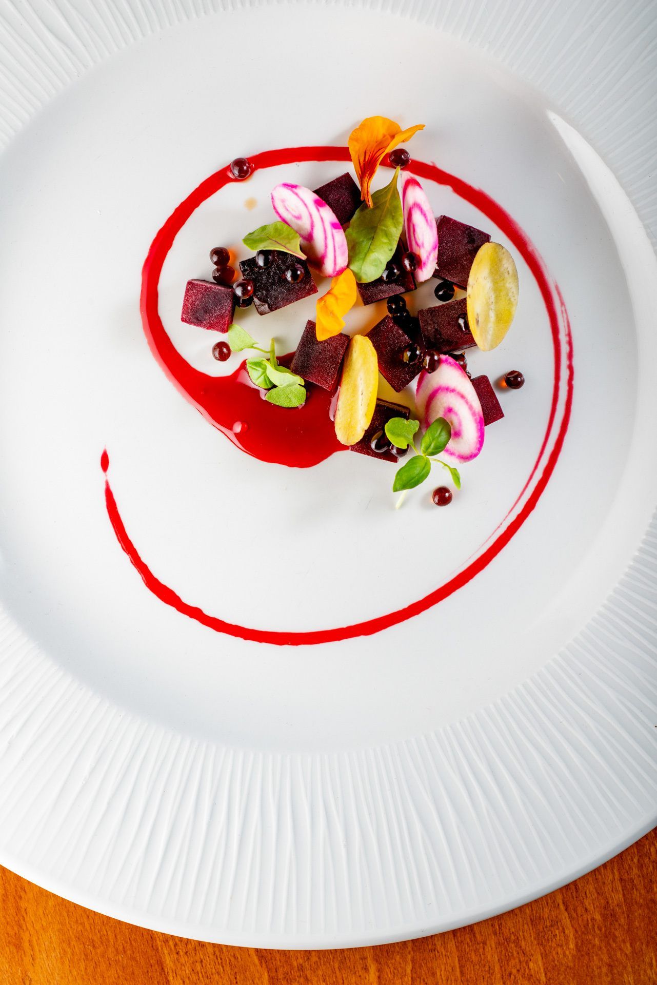 A white plate with a swirl of food on it