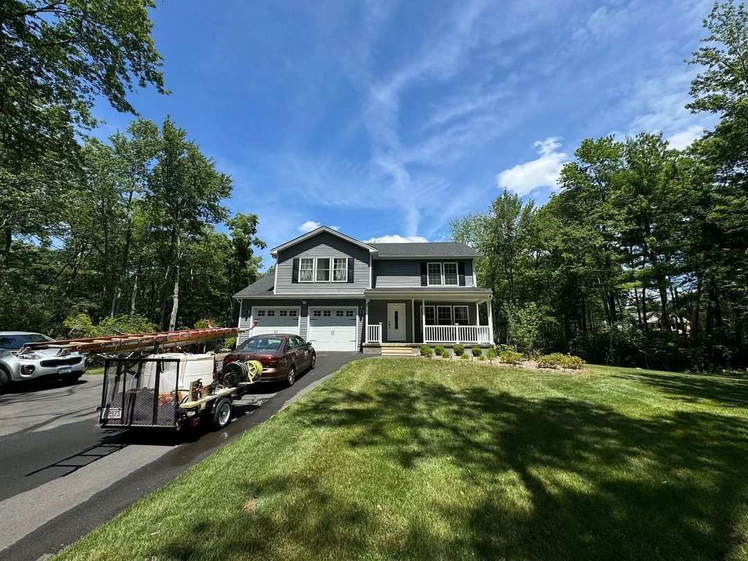 A large house with a lot of cars parked in front of it.