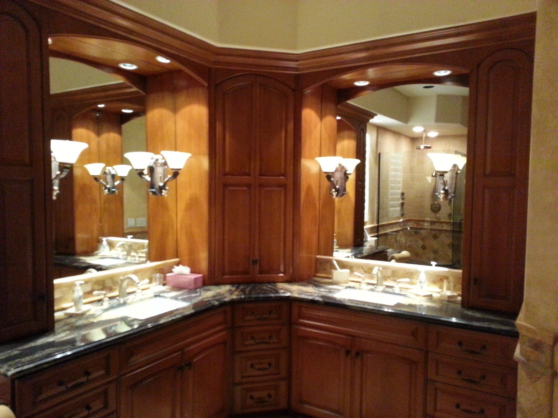 A bathroom with two sinks and two mirrors