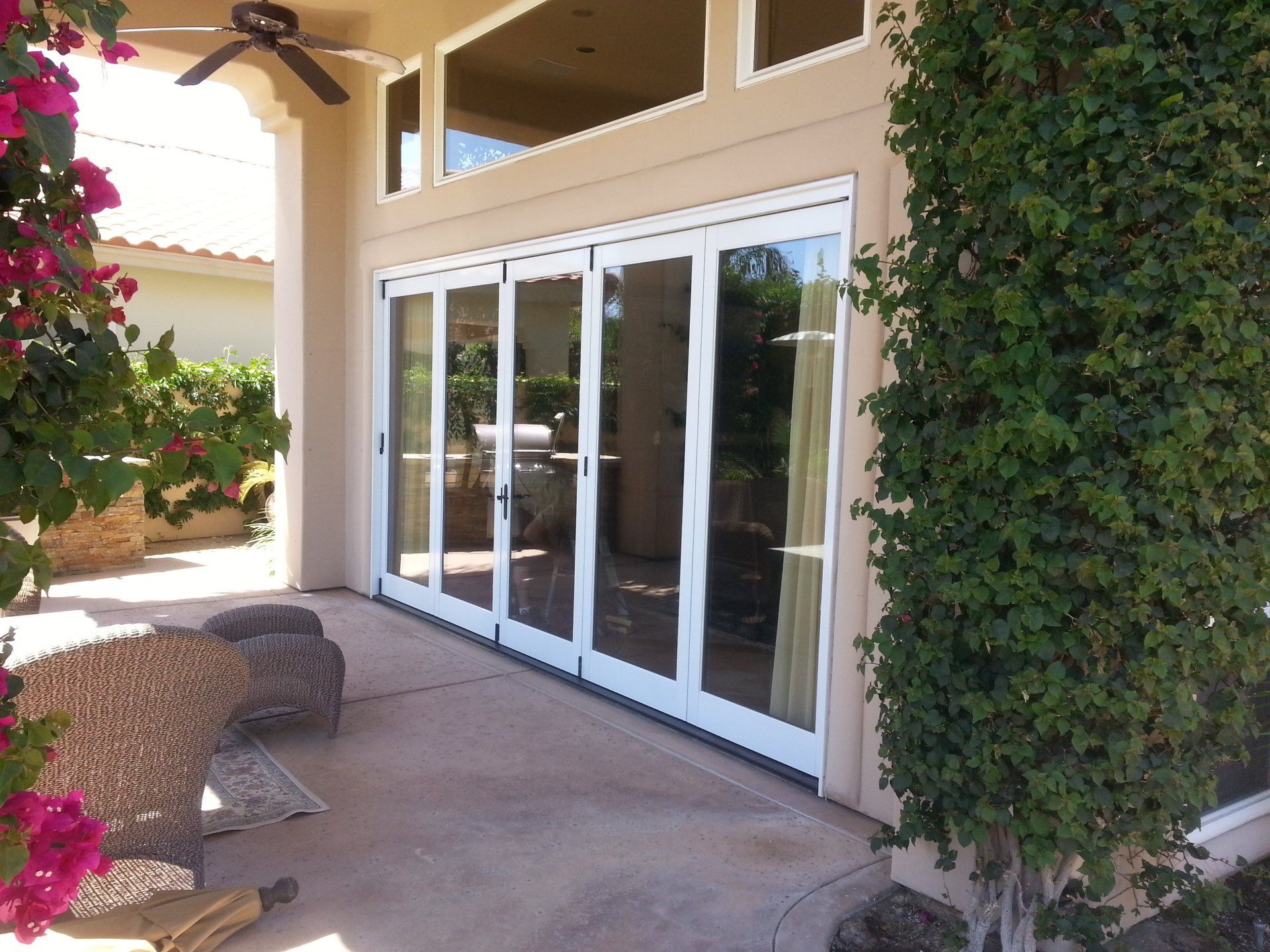 A house with a lot of windows and a ceiling fan