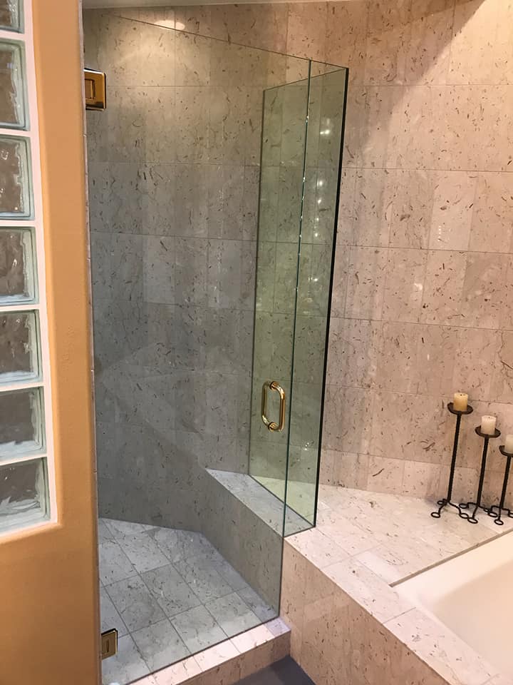 A bathroom with a walk in shower and a bathtub.