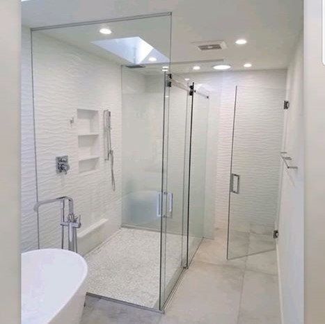 A bathroom with a walk in shower and a bathtub.
