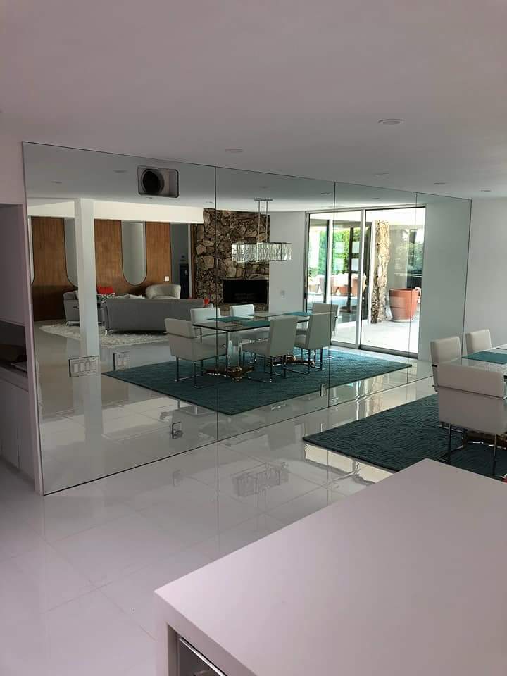 A living room with a dining room table and chairs and a fireplace.