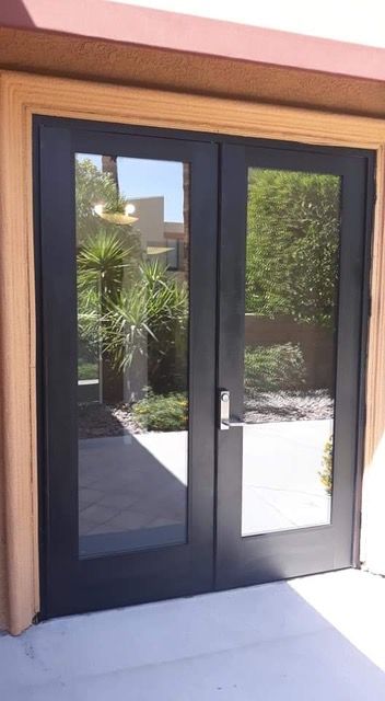 A pair of black sliding glass doors leading to a patio.