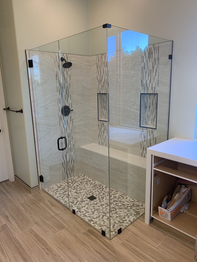 A bathroom with a walk in shower and a bathtub.