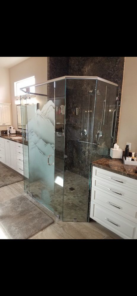 A bathroom with a walk in shower and a sink.
