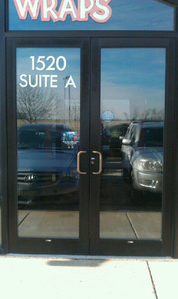A glass door with a sign that says wraps on it