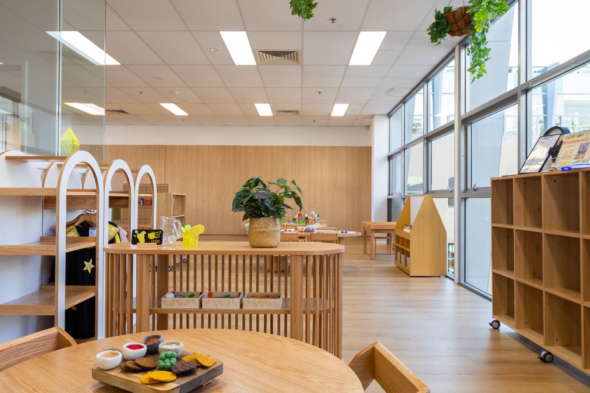 A large room with a table and chairs in it.