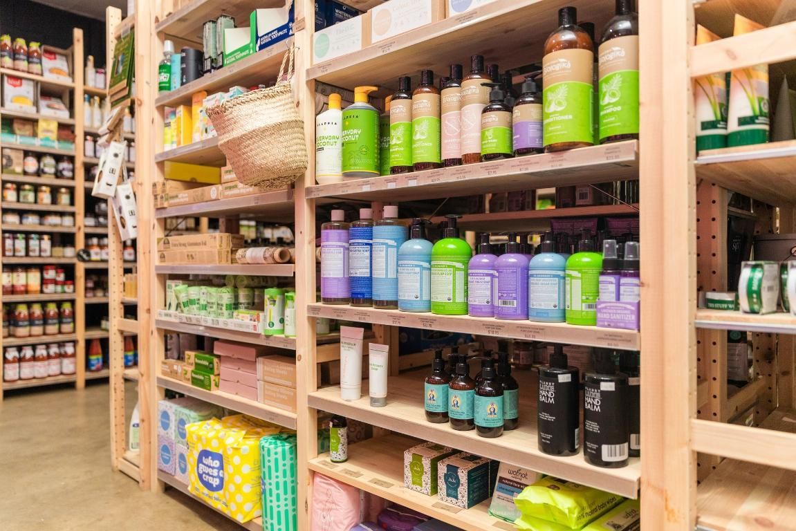 A Grocery Store Filled With Shelves Filled With Lots Of Bottles Of Cosmetics — The Real Grocer In Golden Beach, QLD