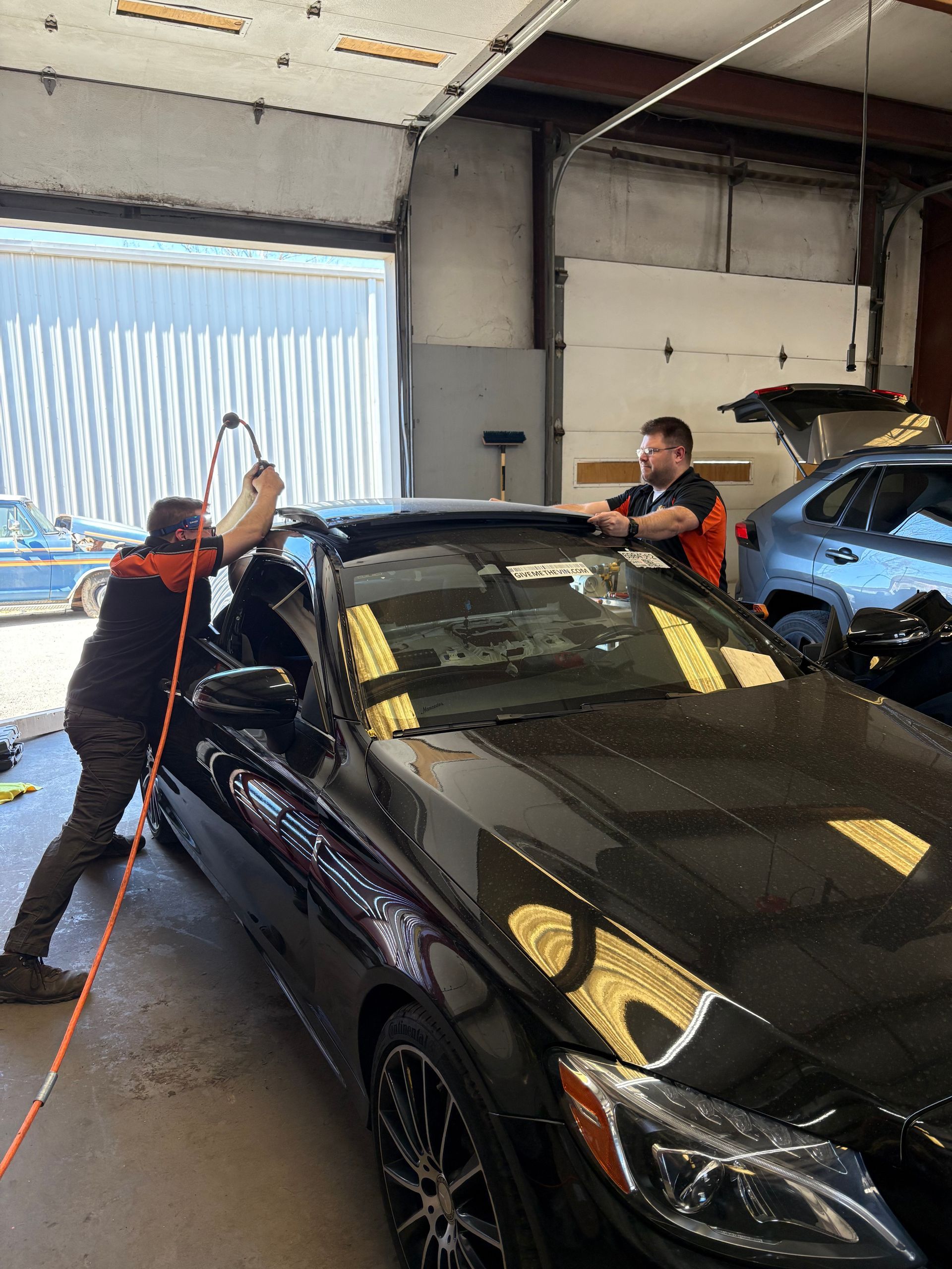 Very carefully cutting the damaged sunroof track out of a Mercedes