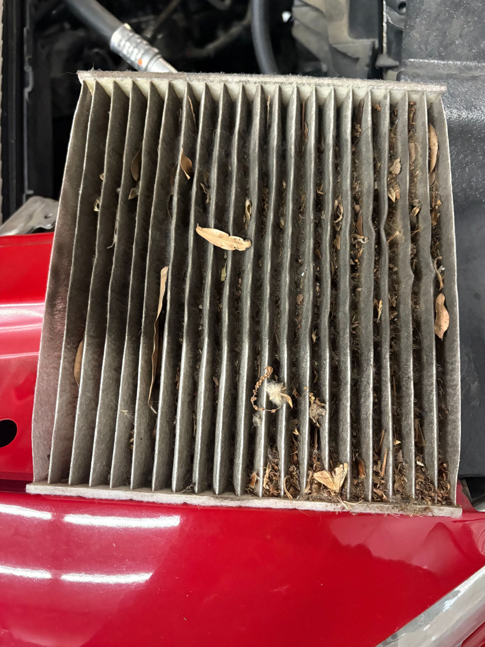 The image shows a vehicle's dashboard fully disassembled for a major repair, likely the replacement of an AC evaporator core.