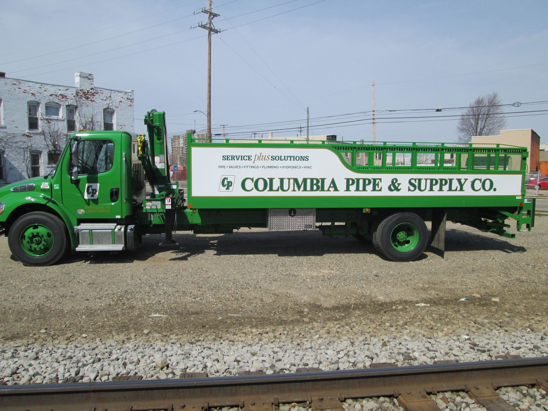 A green and white columbia pipe and supply co truck