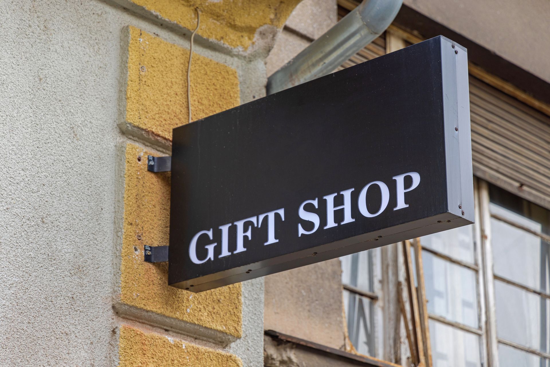 Exterior signage for a gift shop with a vibrant, eye-catching sign displaying store name. Exterior signage for a gift shop with a vibrant, eye-catching sign displaying store name.