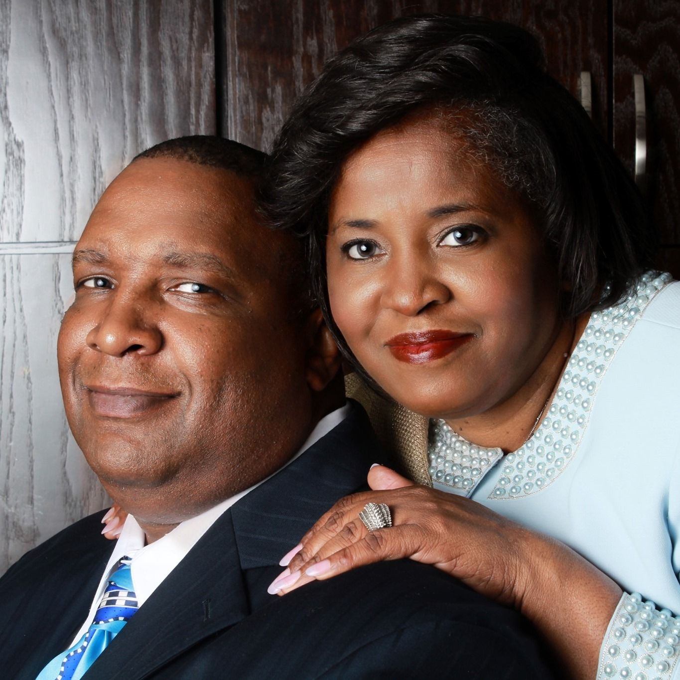 A man and woman are posing for a picture