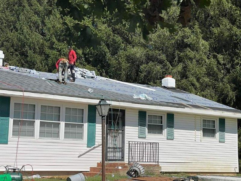 men repairing roof on home