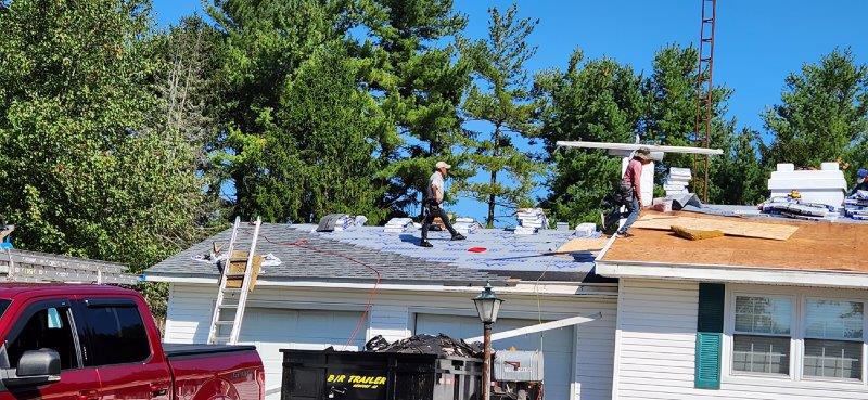 men working on repairing roof