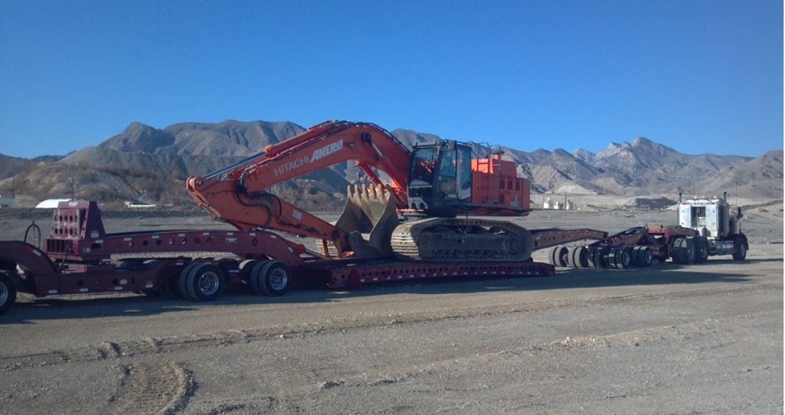 Trailer Truck — Red Trailer Truck Carrying The Backhoe in Las Vegas, NV