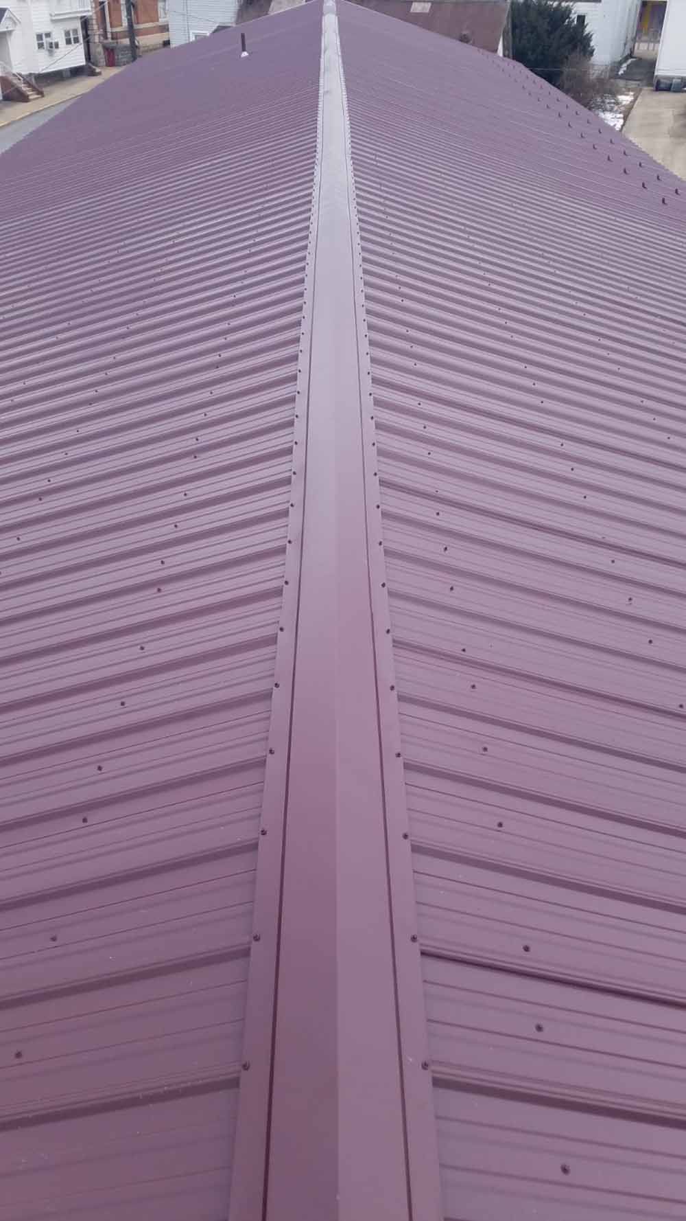 Dark red metal roof with ridgeline, corrugated texture.