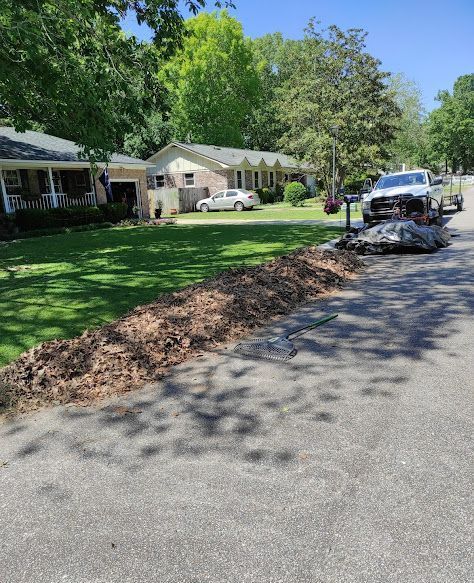 A truck is parked on the side of the road next to a house.