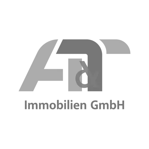 A black and white logo for a company called att immobilien gmbh.