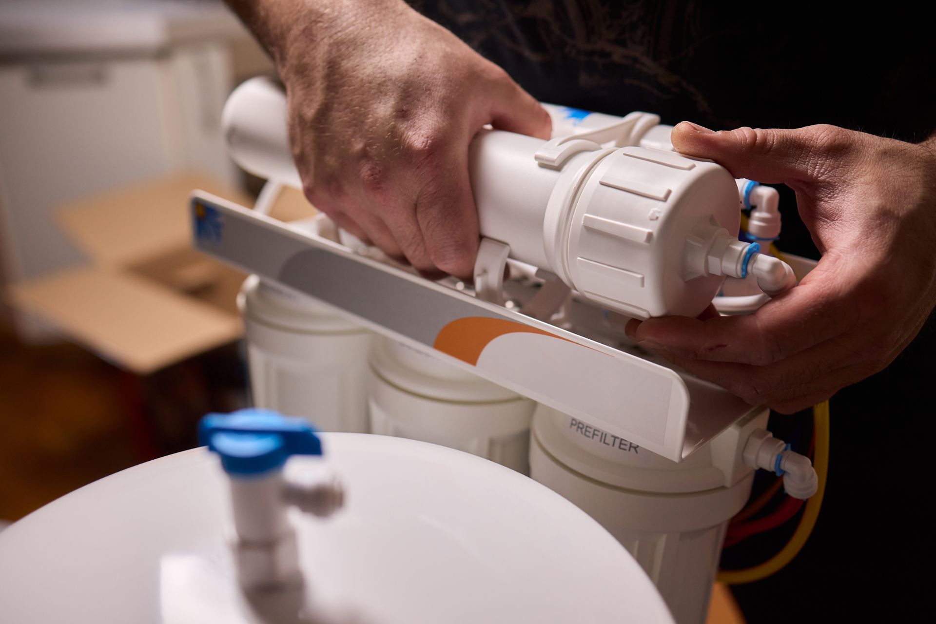 Hands assembling a white water filter system. Hands assembling a white water filter system.