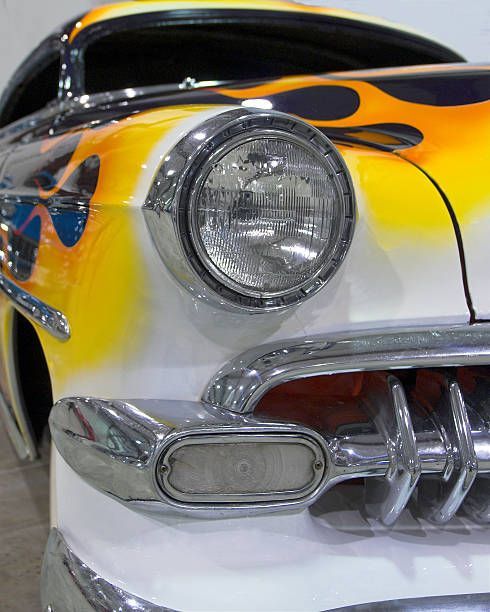 A yellow and white car with flames painted on it