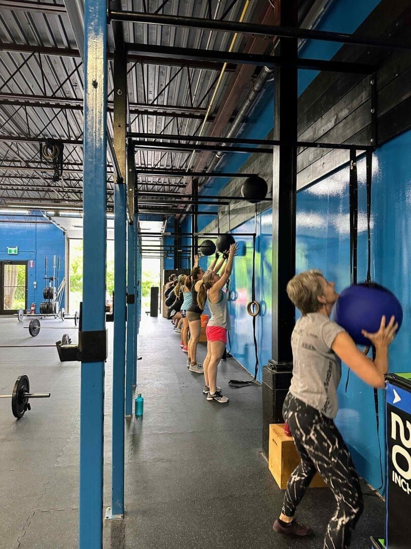 A group of people are doing exercises in a gym.